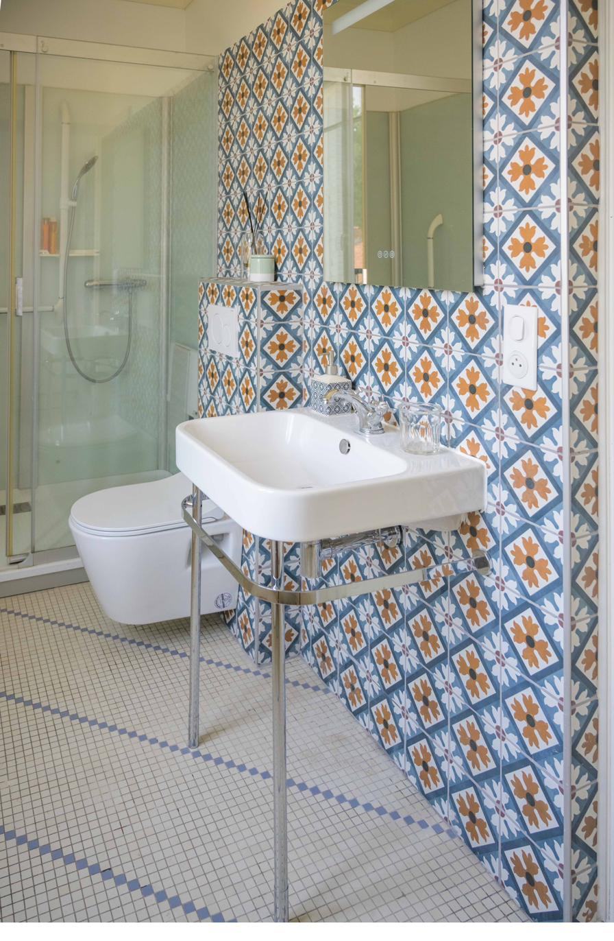 Bathroom with patterned tiles and walk-in shower