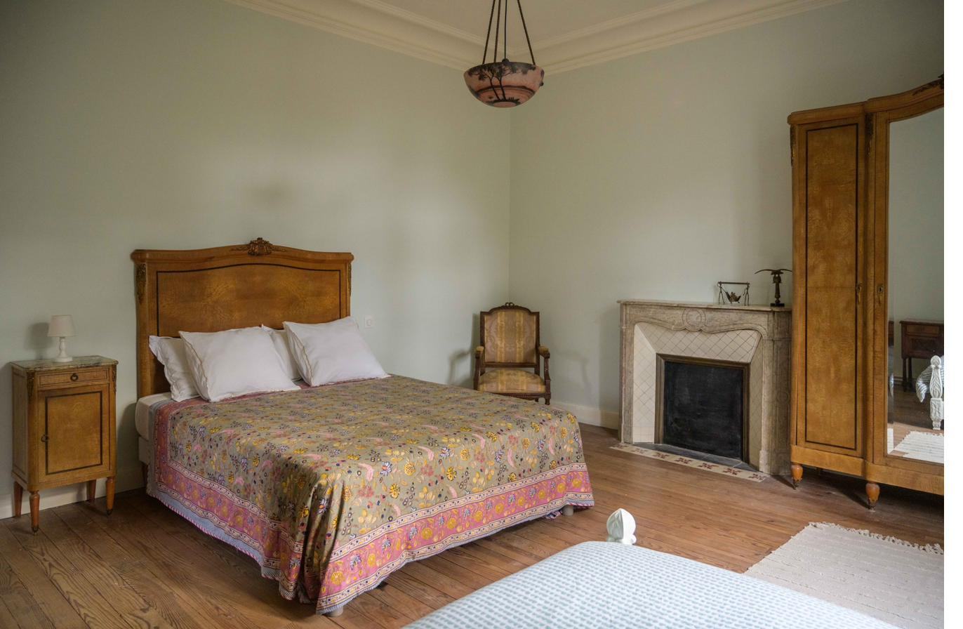 Bedroom with marble fireplace and walnut furniture