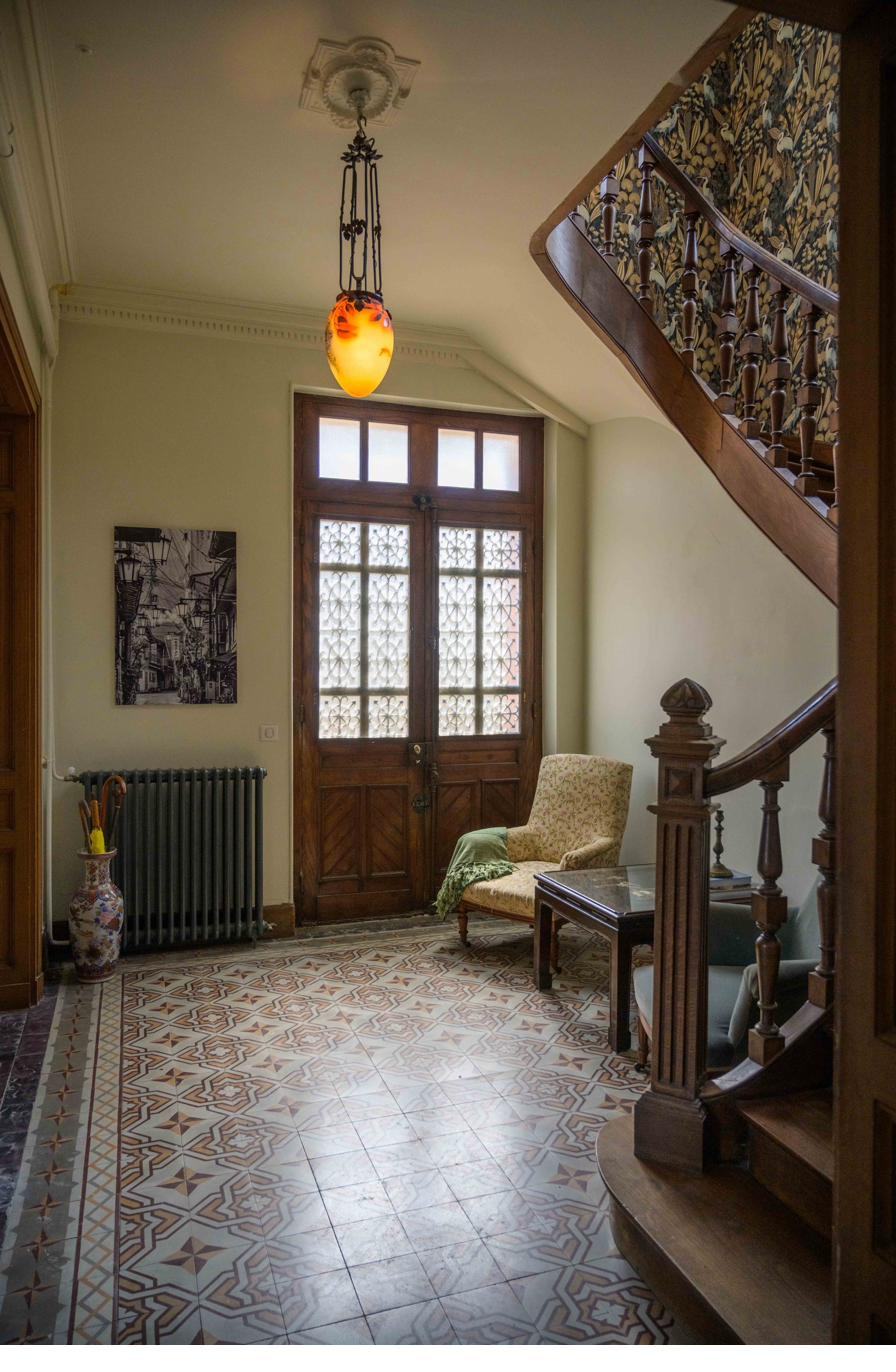 Entrance hall with original tiled floor and oak staircase