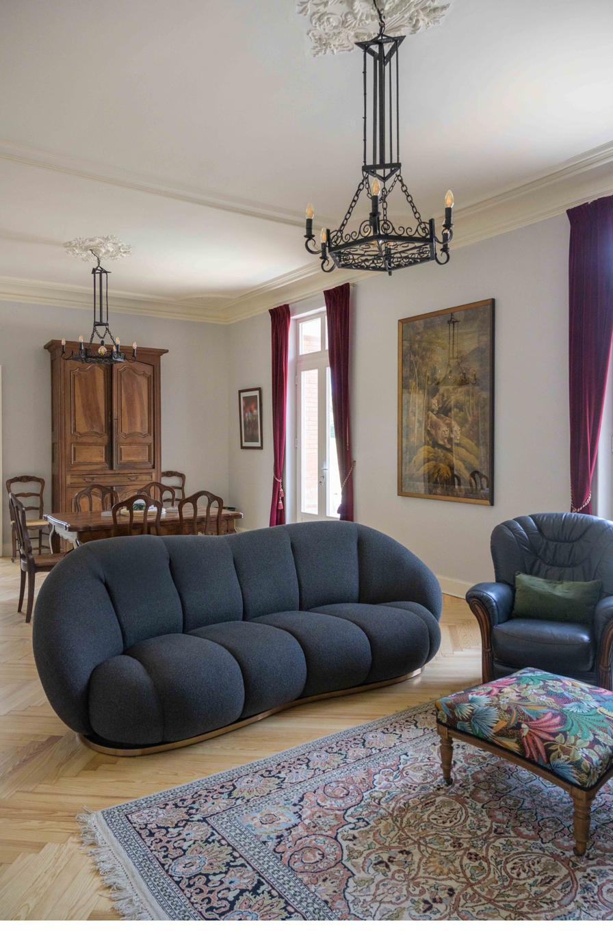 Lounge with sofa, armchair and antique armoire